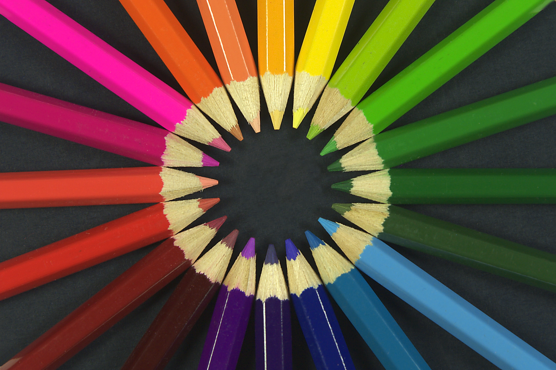 Radial arrangement of coloured pencils — visualizing the full chromatic range behind the color-bombing trend.
