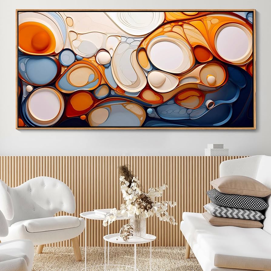 Large abstract statement artwork in warm tones hanging above a minimalist white sofa against a wood-slat accent wall — the single photo-defining piece the article calls out.